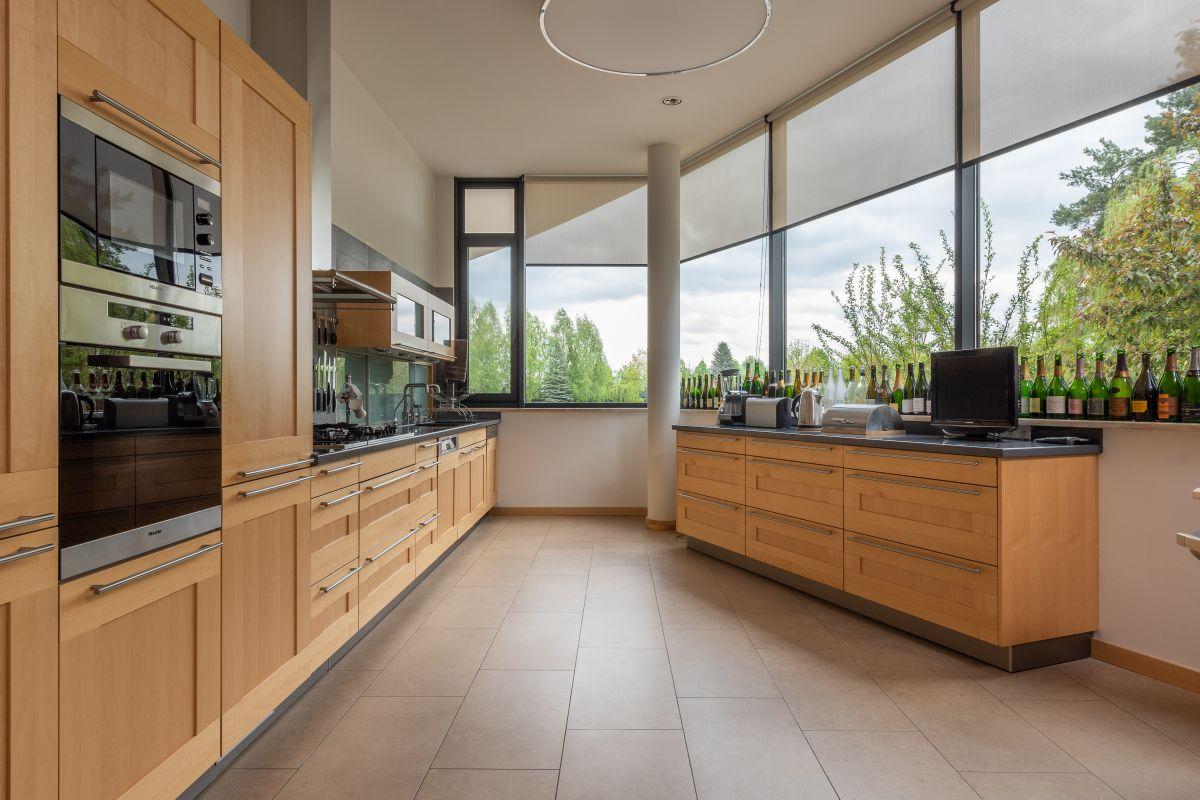 Illustrative kitchen with full-height wooden cabinets and an island